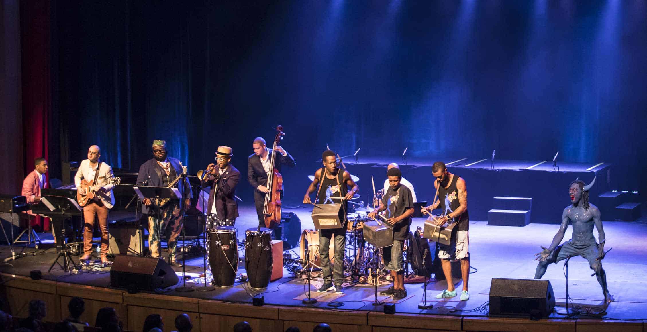 Blue Devil onstage with Etienne Charles and band. Photo: Maria Nunes